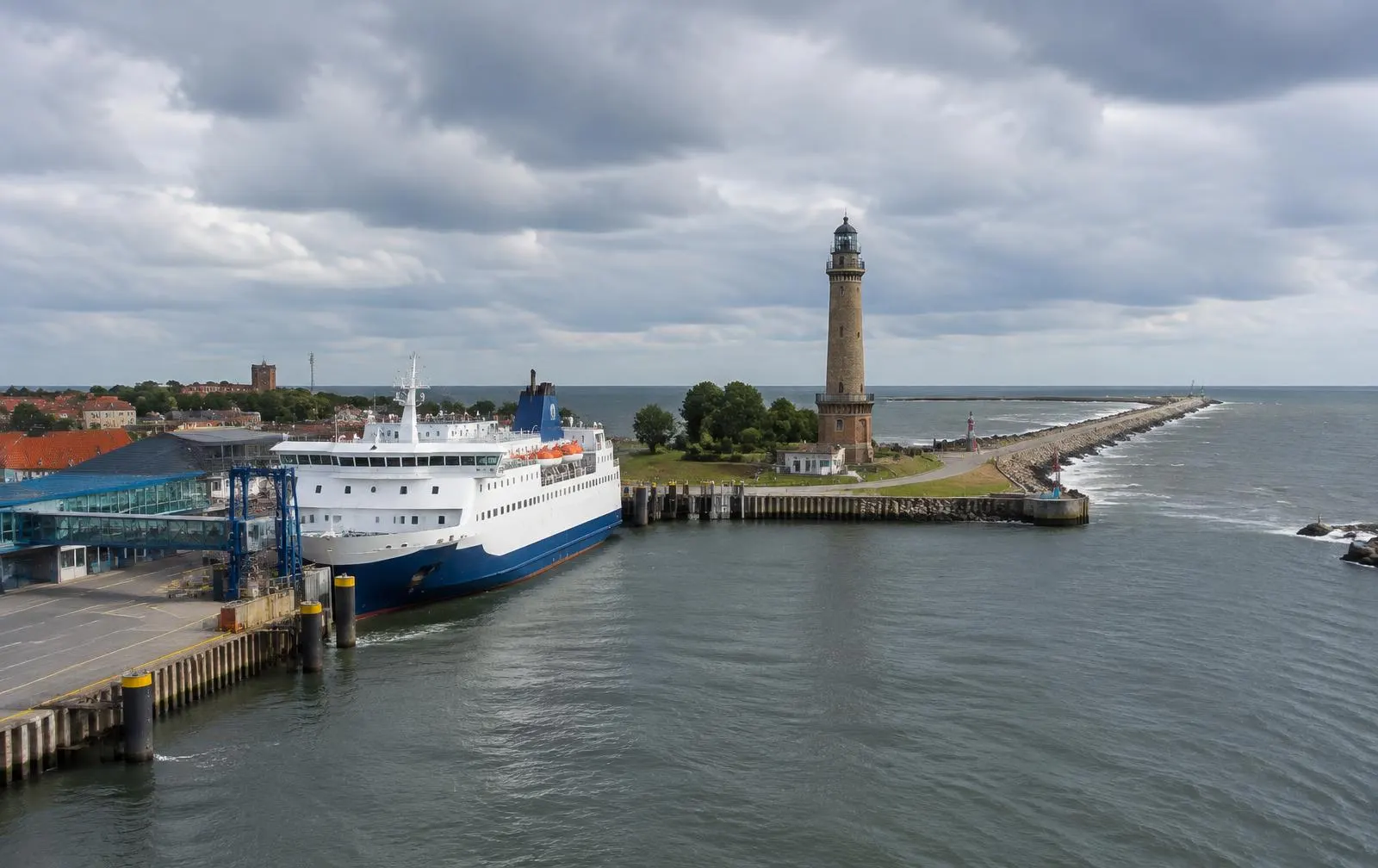 Ferry at a terminal near a lighthouse